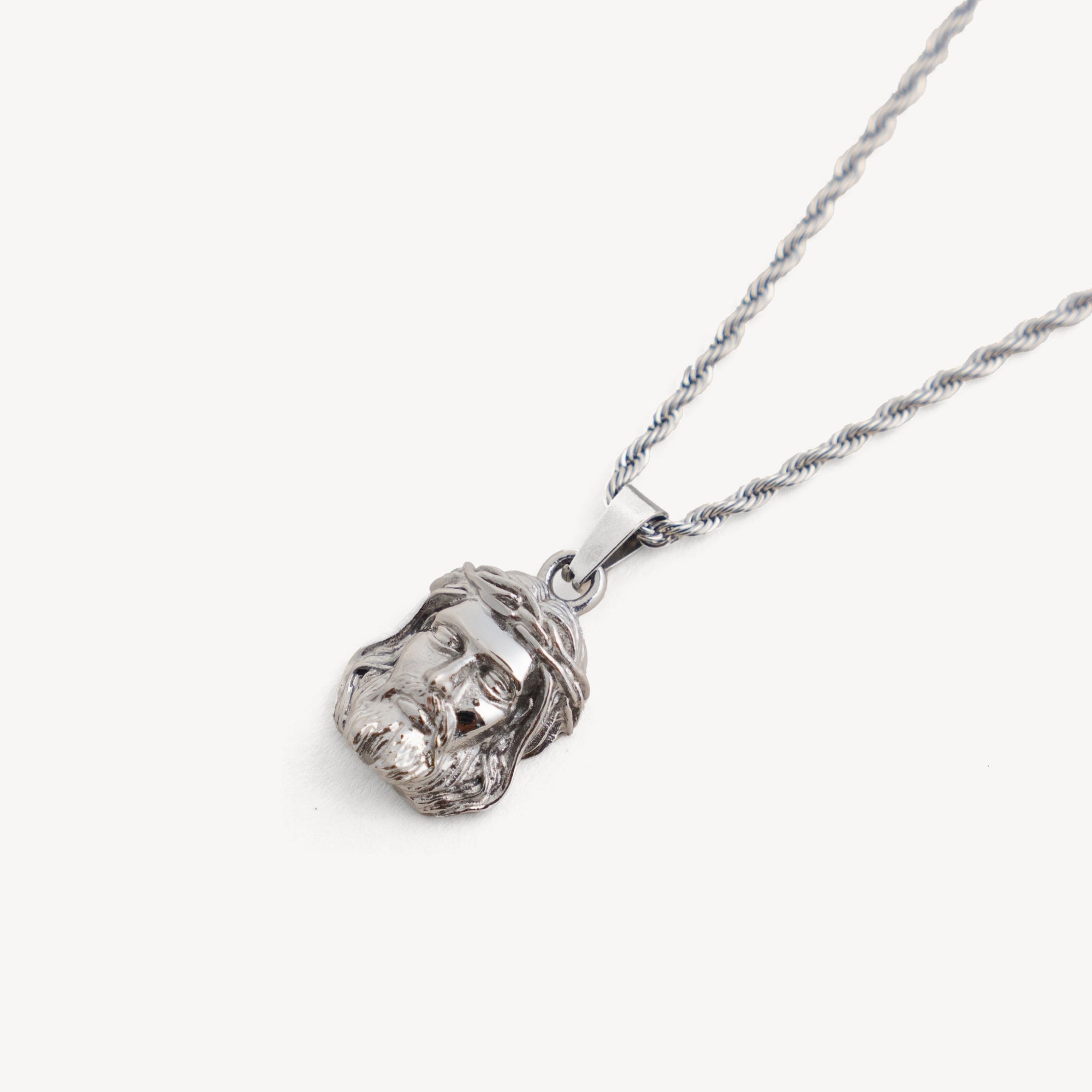 Silver necklace with a detailed pendant on a white background