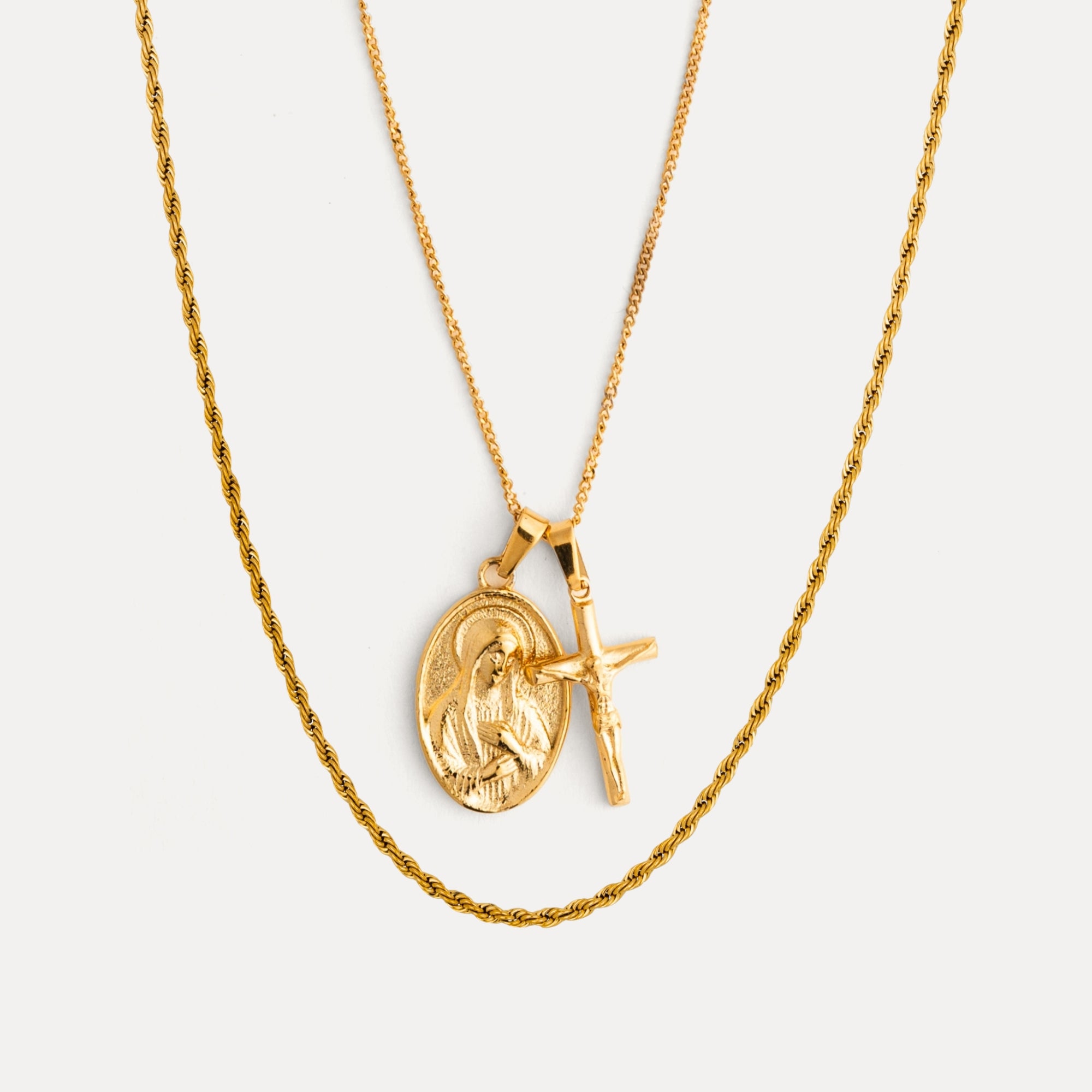 Gold necklace with a pendant on a light gray background