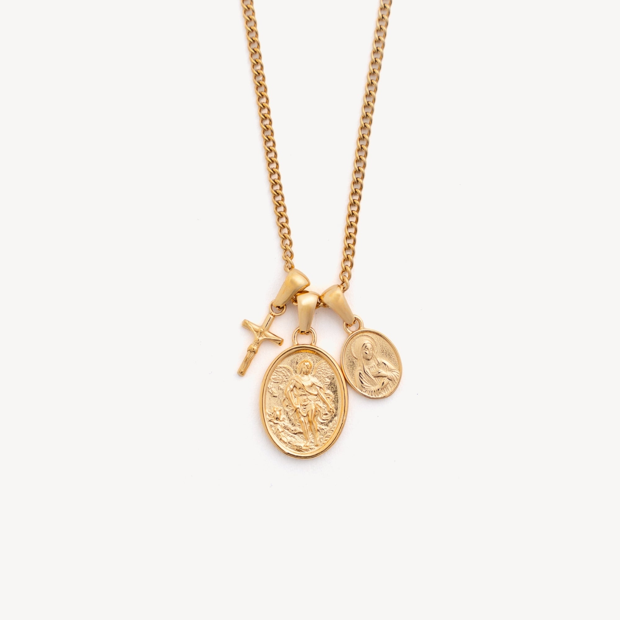 Gold necklace with three pendants on a white background