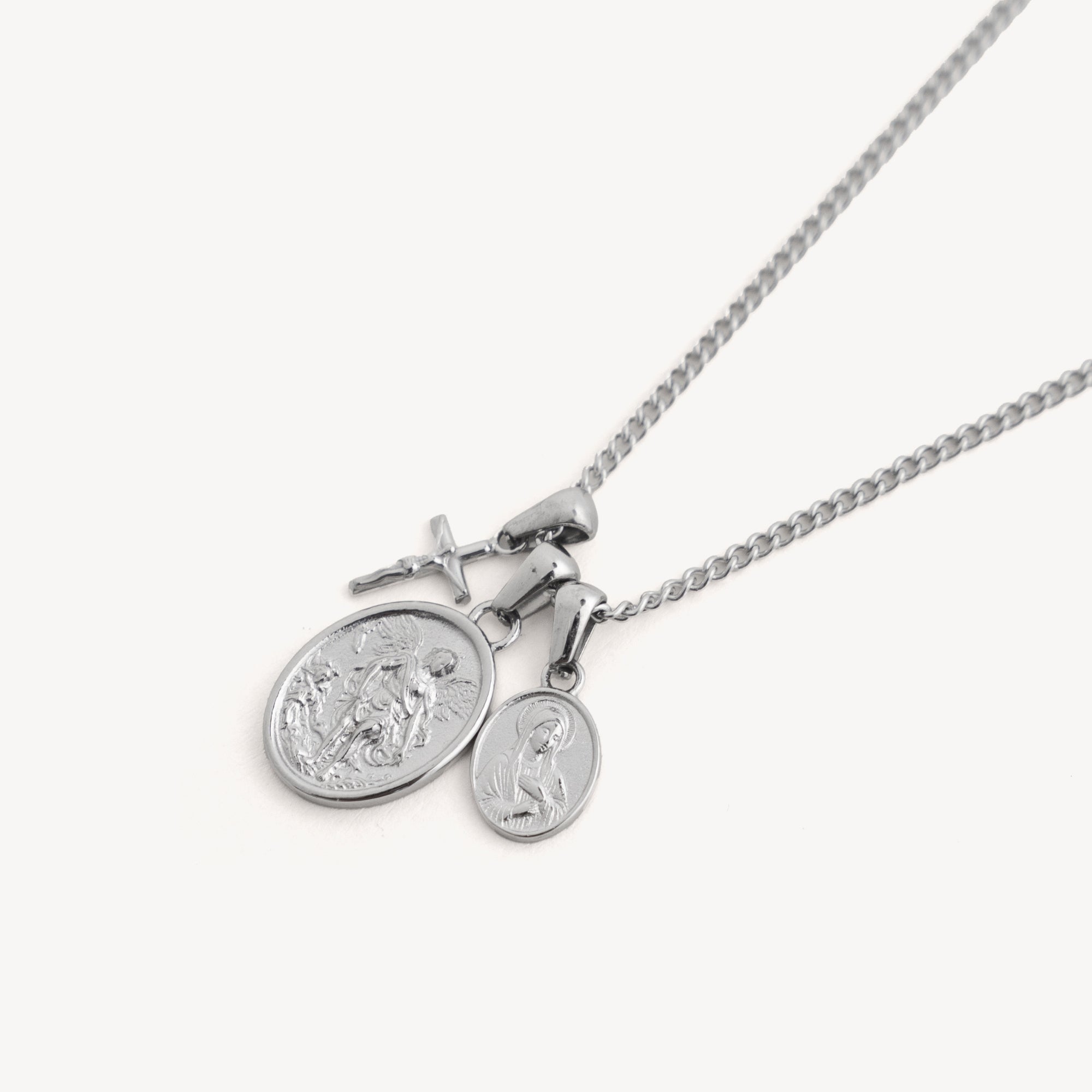 Silver necklace with two round pendants on a white background