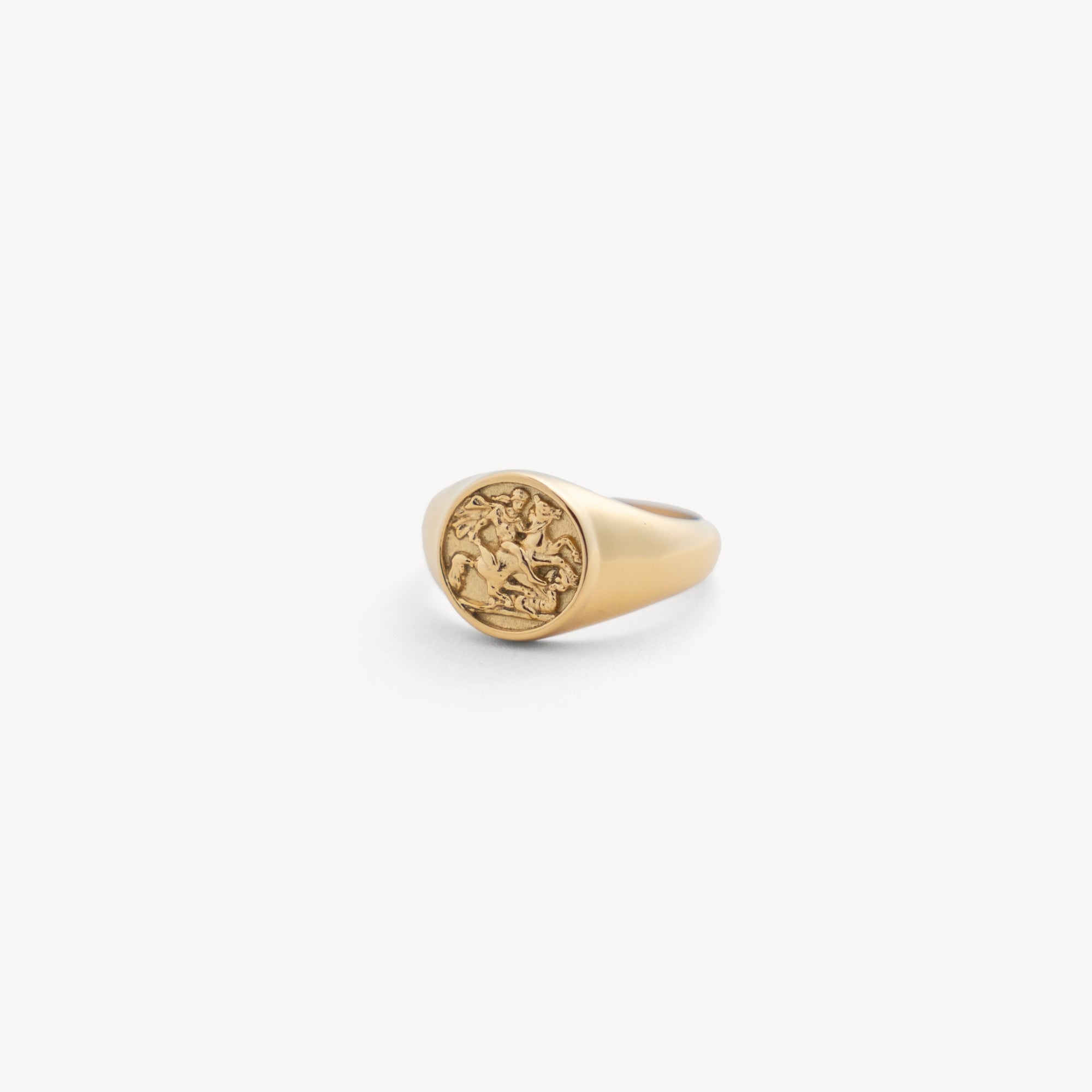 Gold ring with a circular design on a white background