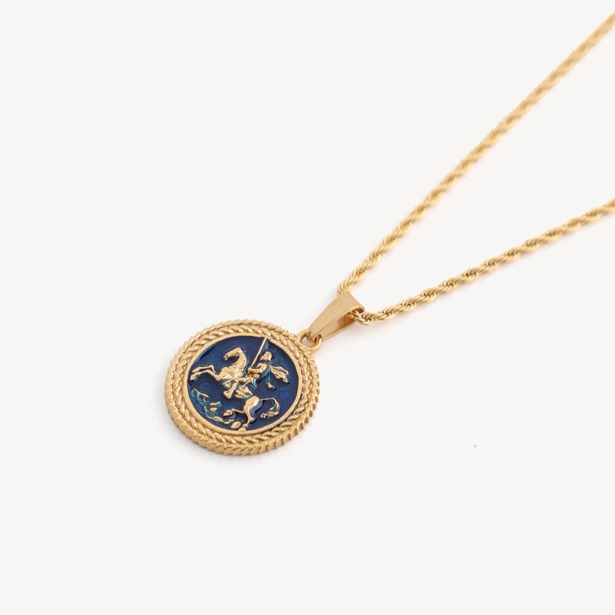 Gold necklace with a blue pendant featuring a lion emblem on a white background
