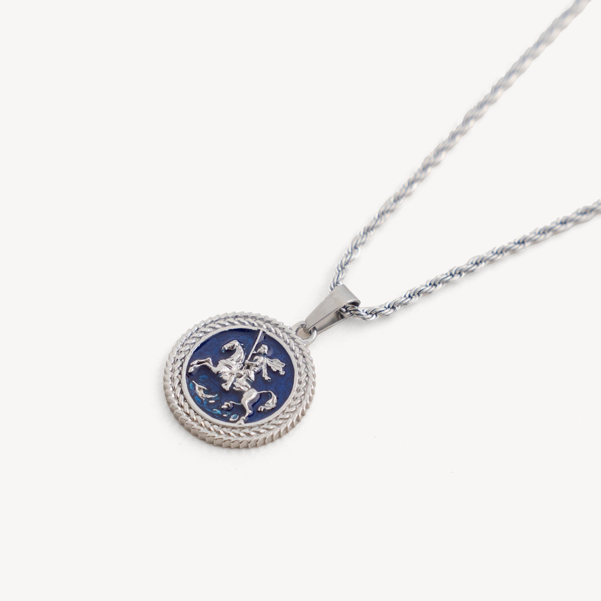 Silver necklace with a round pendant featuring a blue design on a white background