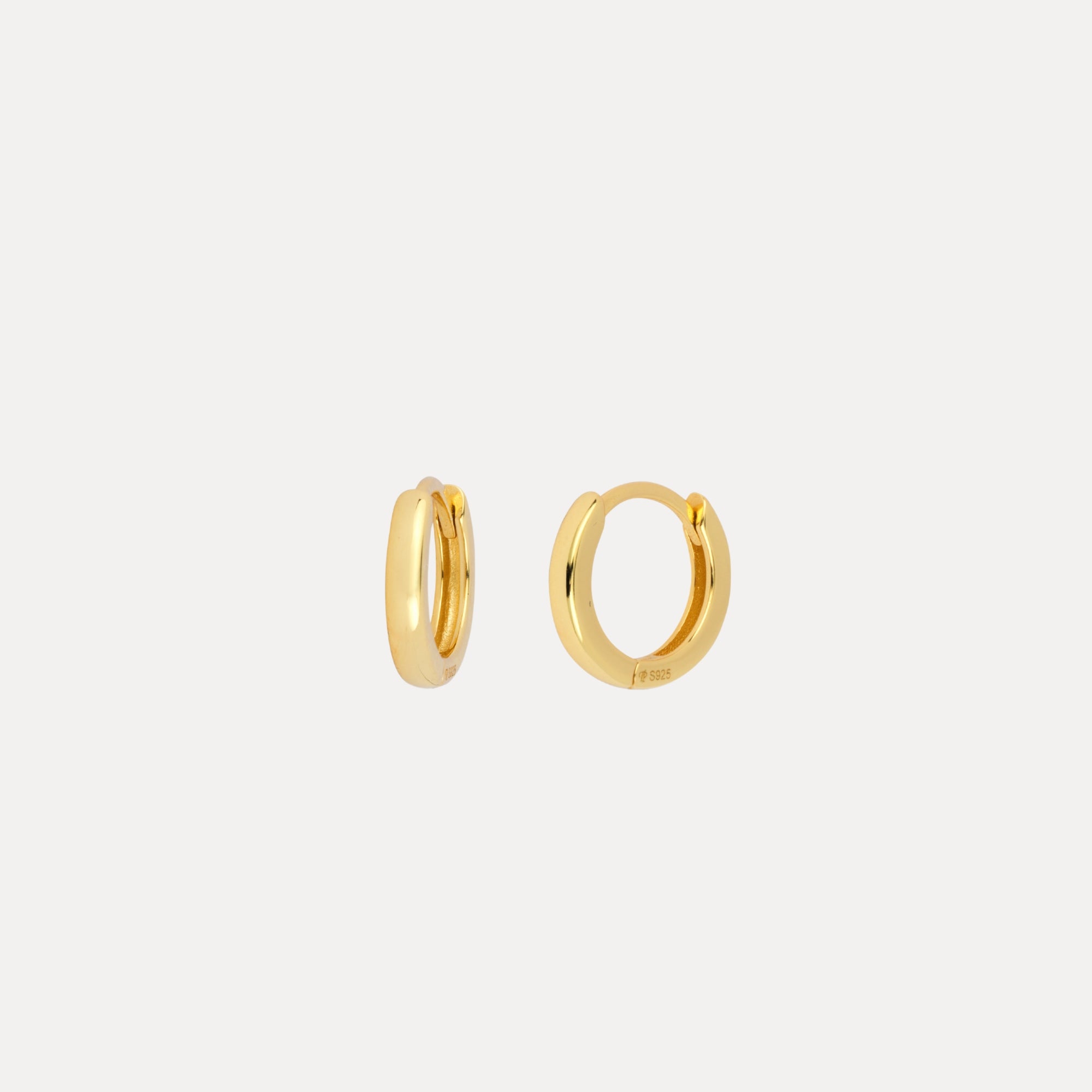 Gold hoop earrings on a white background