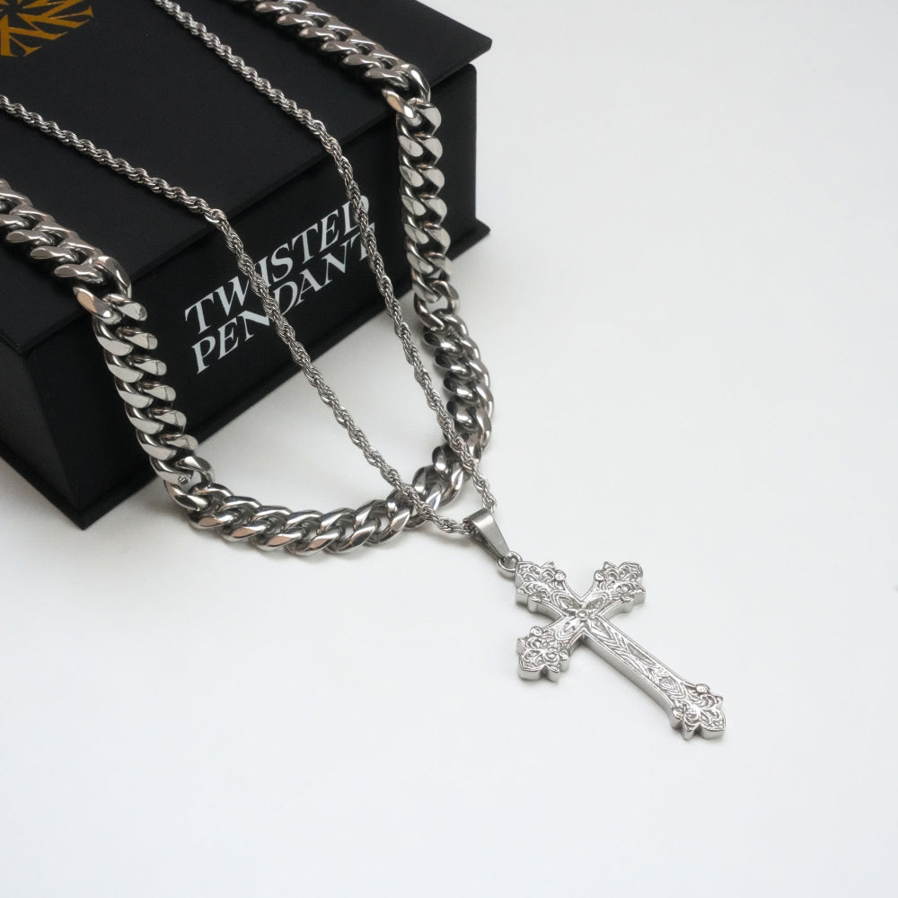 Silver chain necklace with a cross pendant on a white background