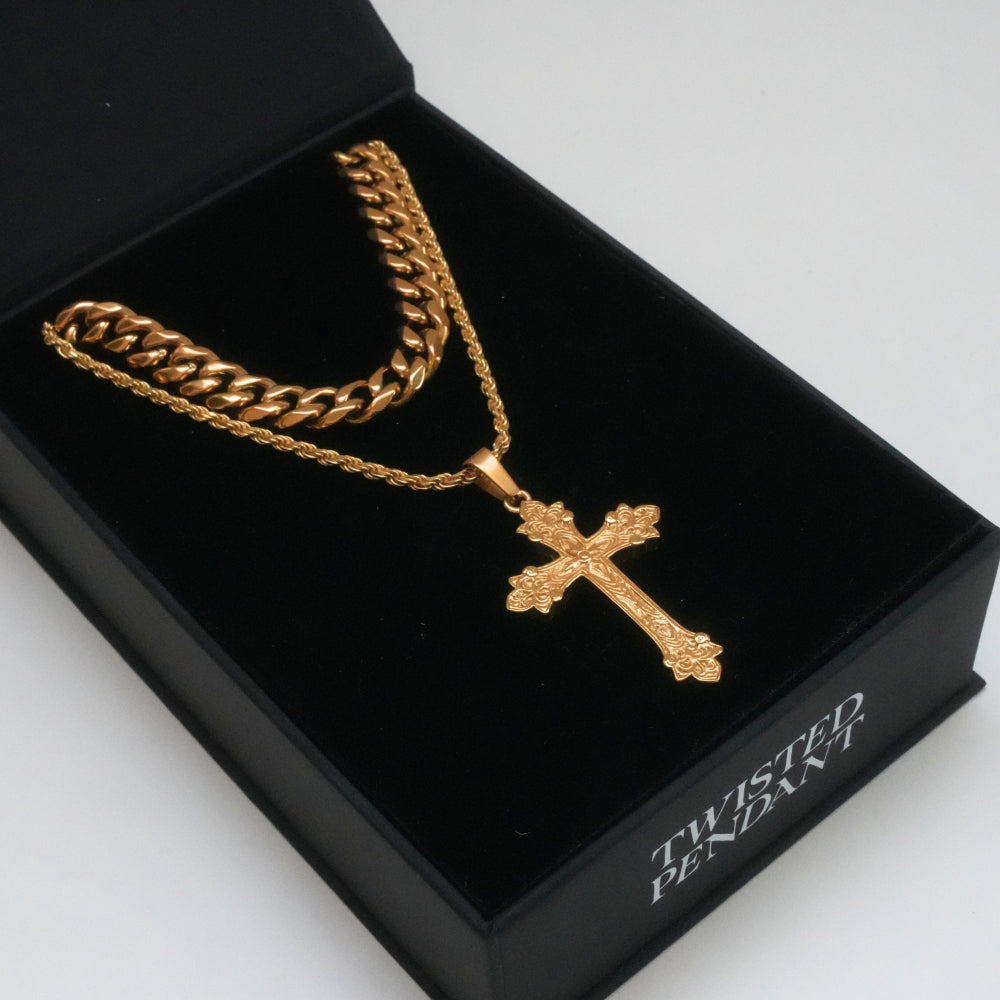 Gold chain with a cross pendant in a black box labeled 'Twisted Pendant'.