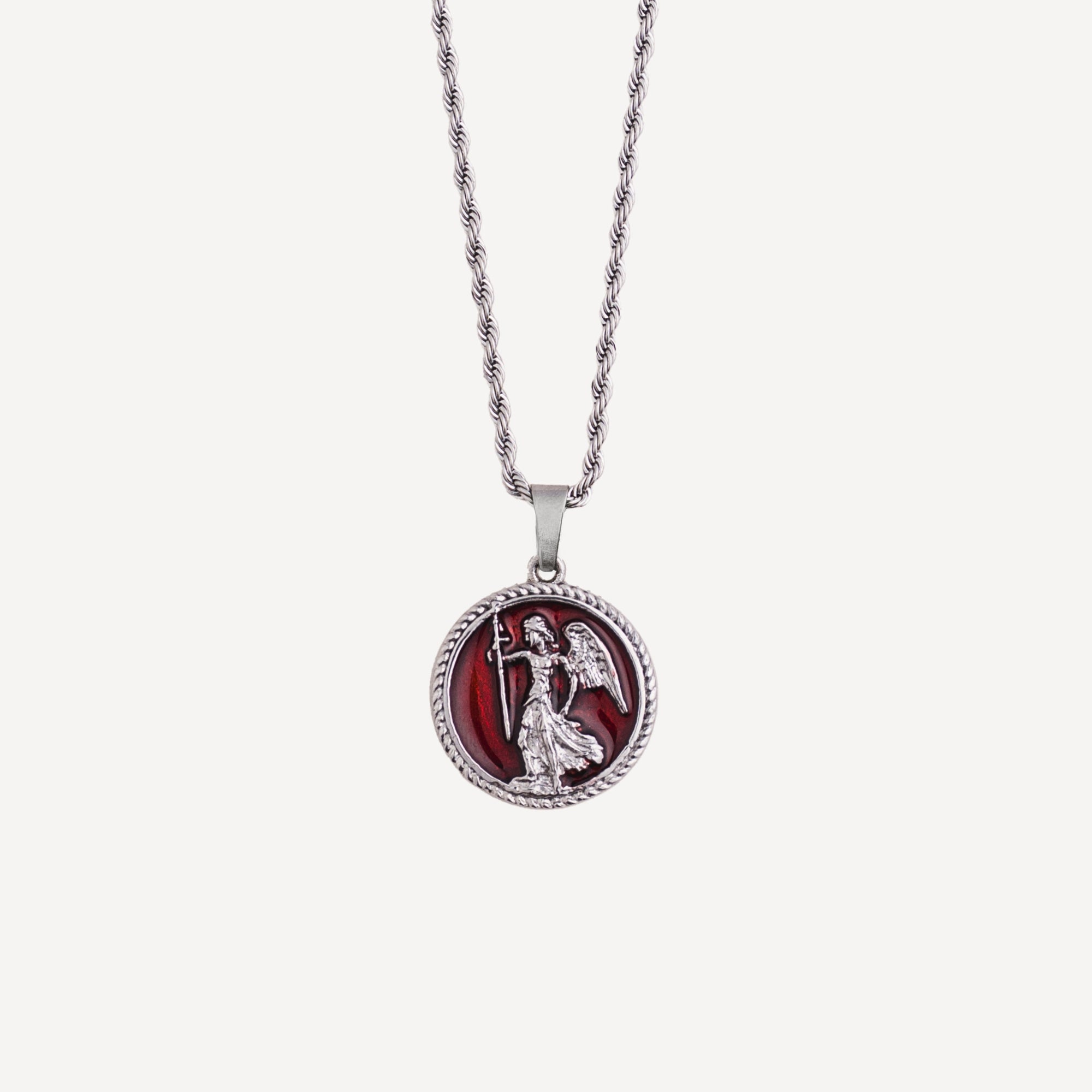 Silver necklace with a red pendant featuring an angel design on a white background