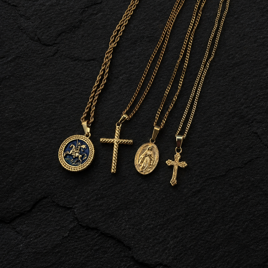 Four gold necklaces with pendants on a black textured background
