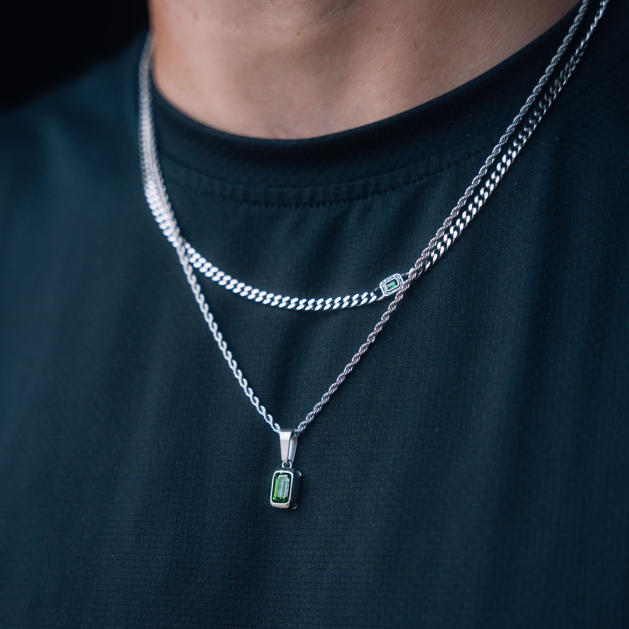 Man wearing a curated silver Saint Michael layered necklace set