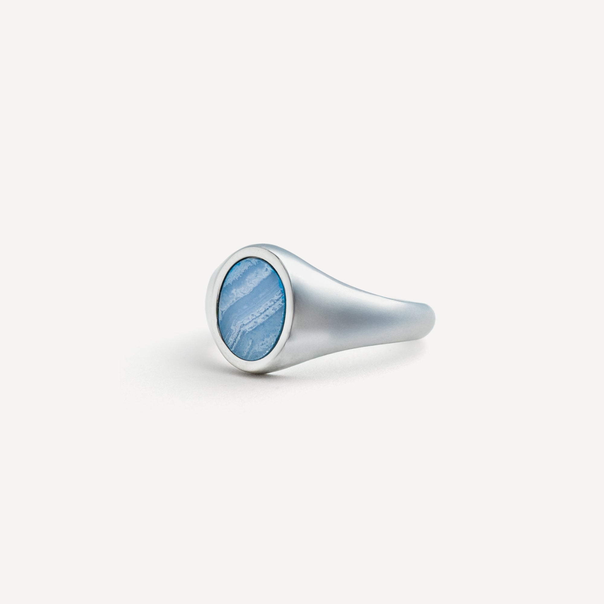 Silver ring with a blue stone on a white background