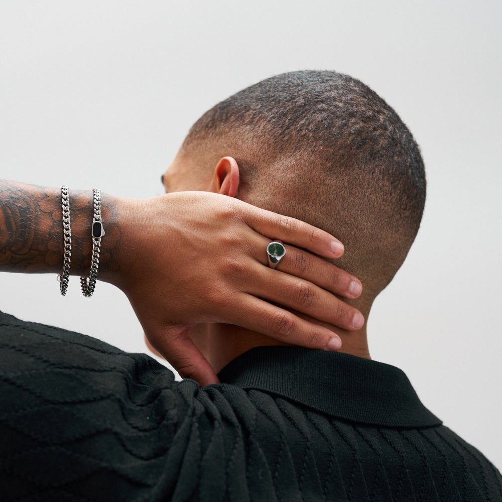 Person wearing a black shirt with a plain background