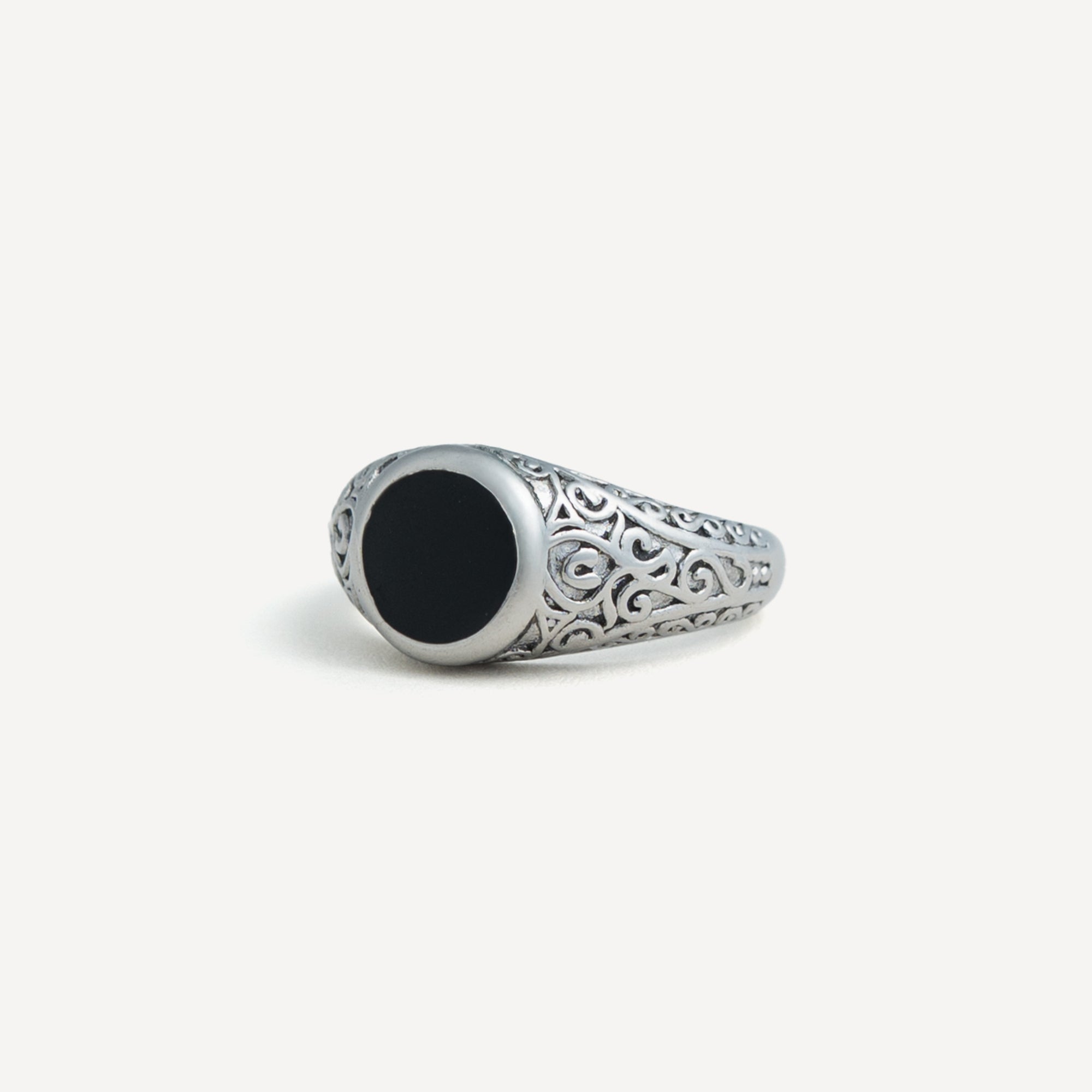Silver ring with black stone on a white background