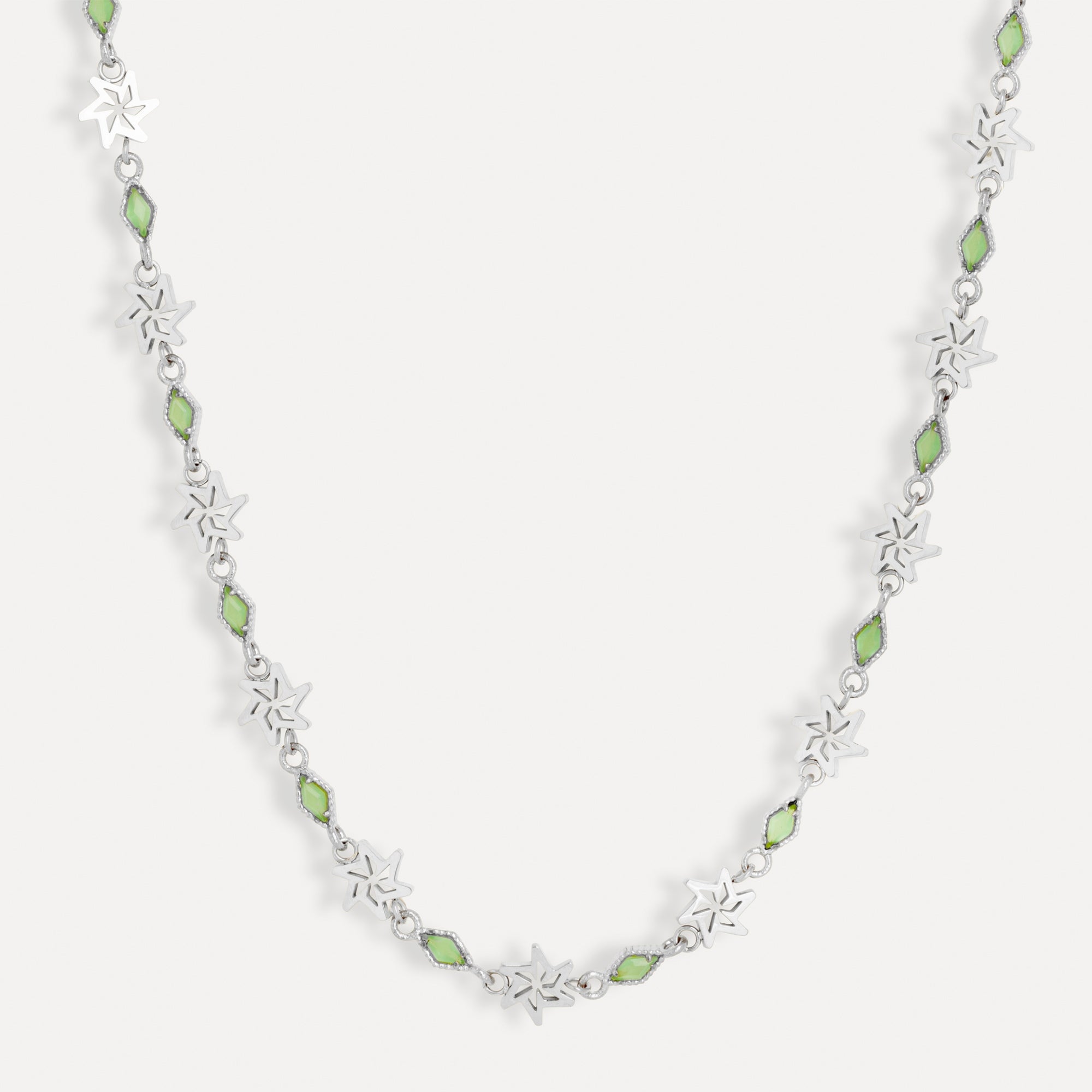 Necklace with green beads and silver floral designs on a white background