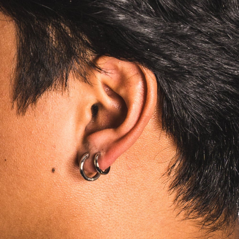 Close-up of an ear with a double-looped earring