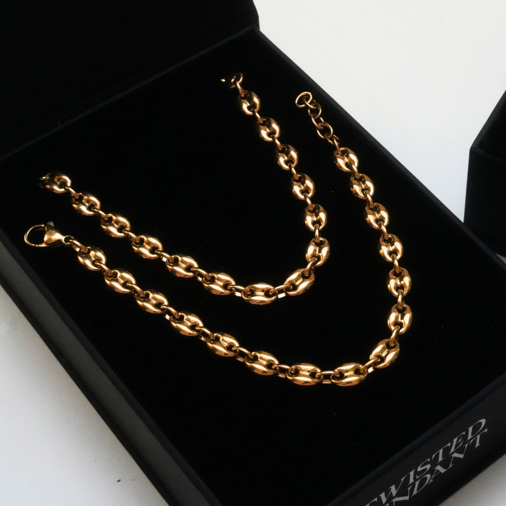 Gold chain necklace on a black jewelry box with 'Twisted End' branding.