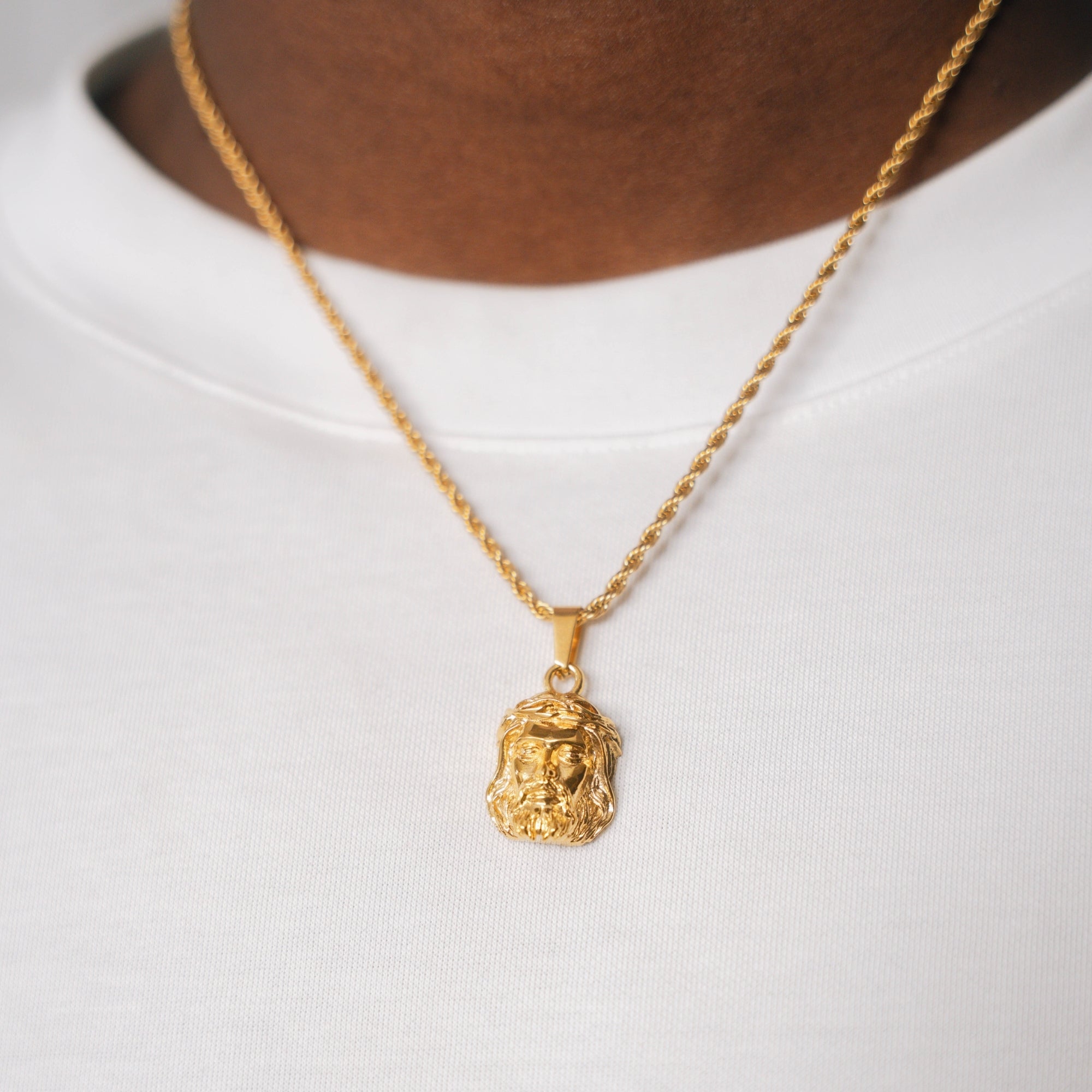 Gold necklace with a pendant on a white background