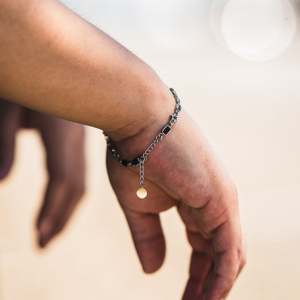 Close-up of a hand wearing a bracelet with a blurred background
