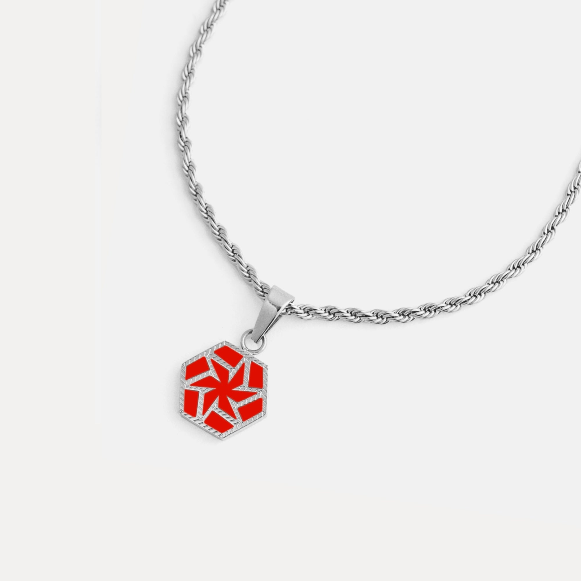 Necklace with a red geometric pendant on a white background