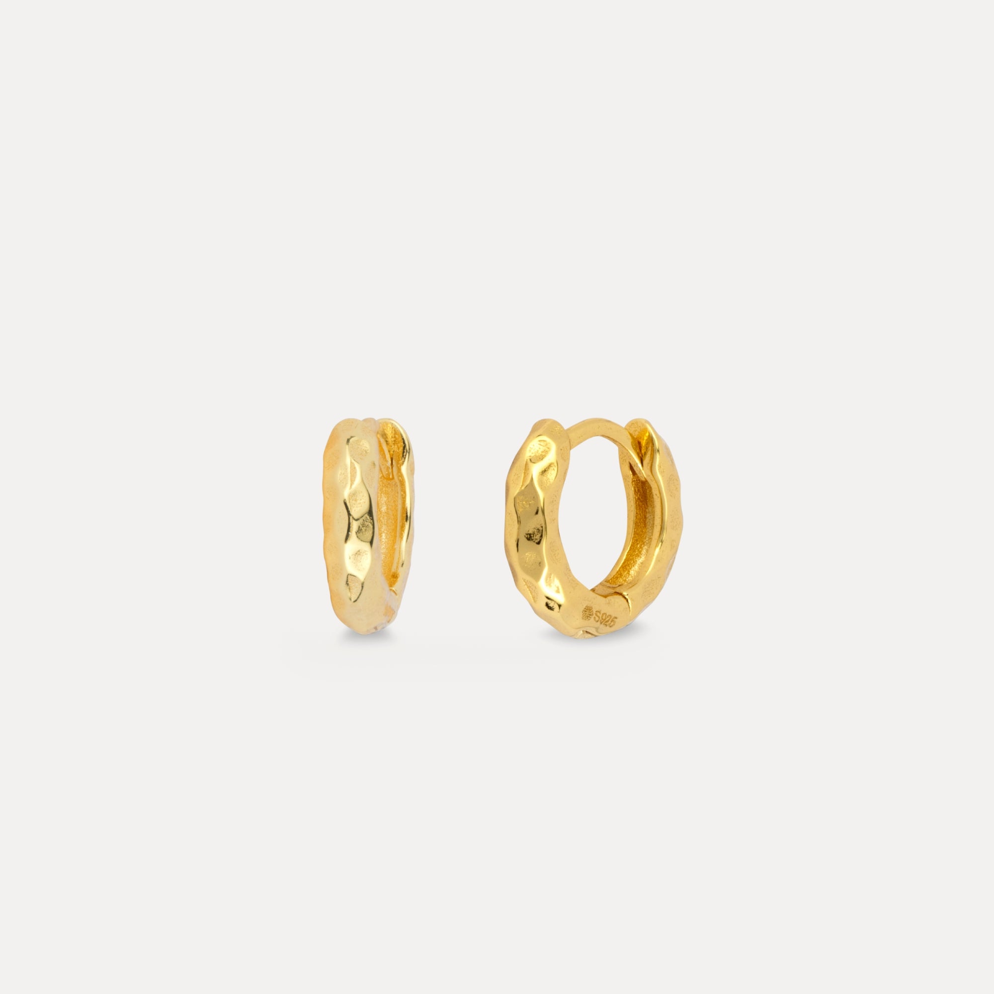 Gold hoop earrings on a light gray background