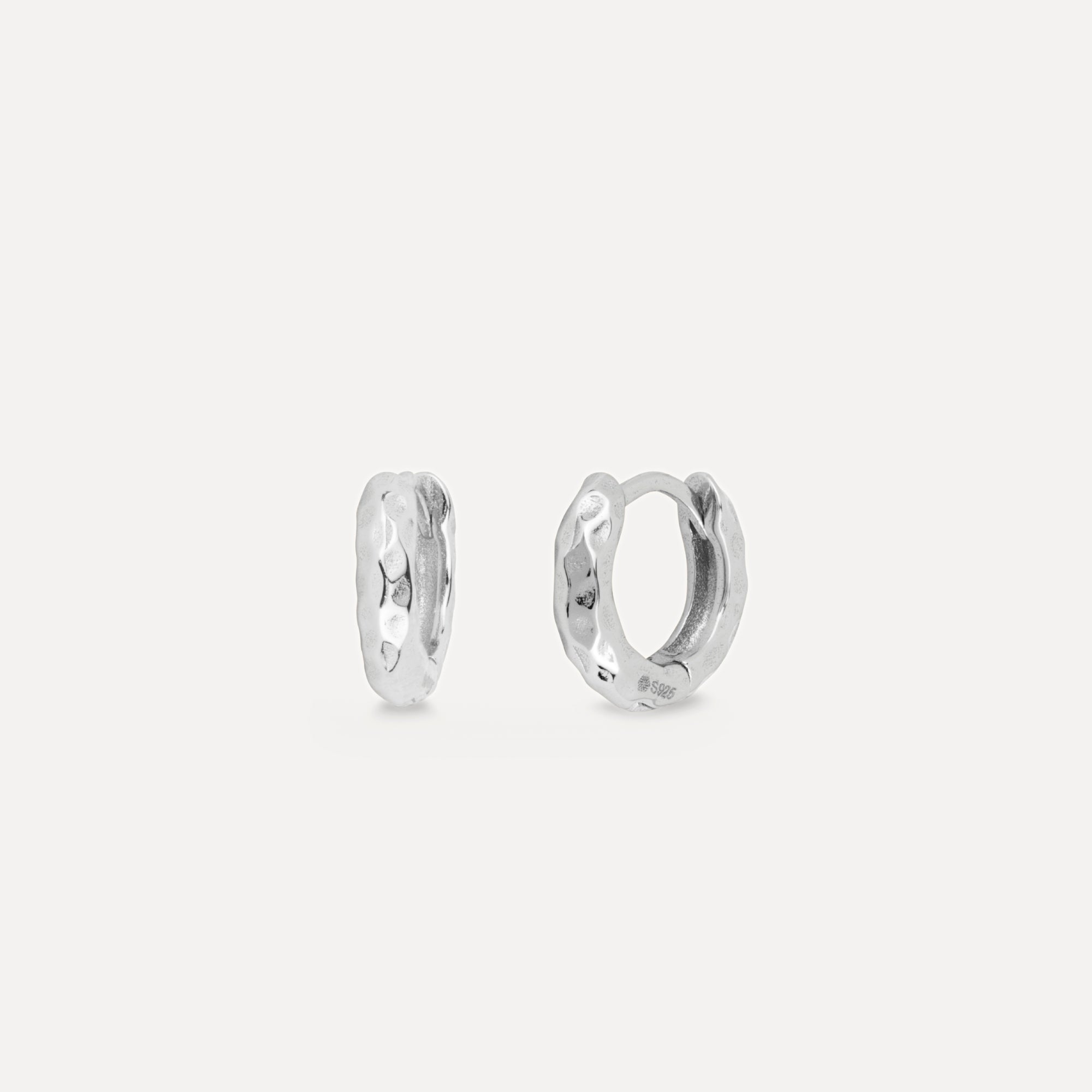 Pair of silver hoop earrings on a light gray background