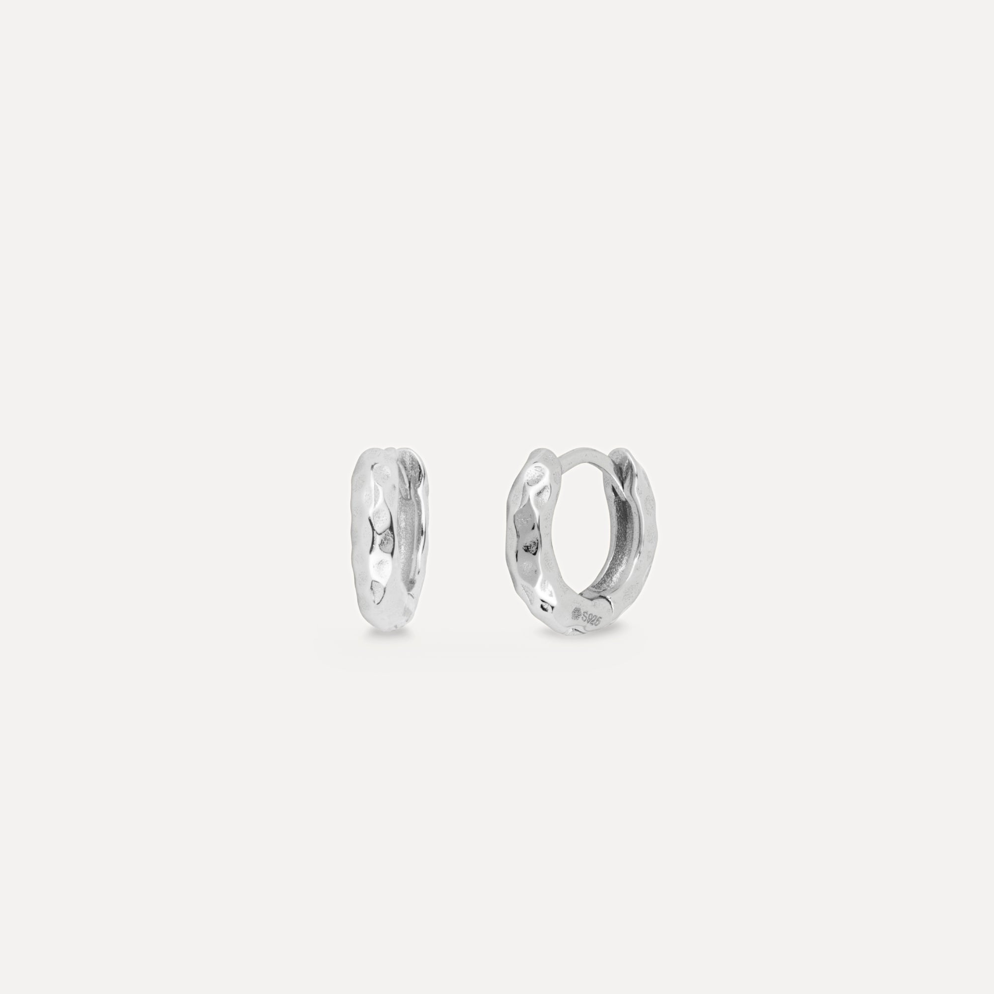 Pair of silver hoop earrings on a light gray background