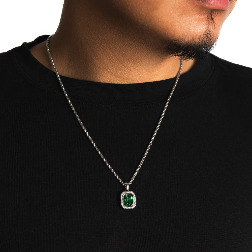 Necklace with a green gemstone pendant on a black background