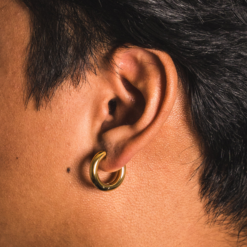 Close-up of an ear with a gold hoop earring