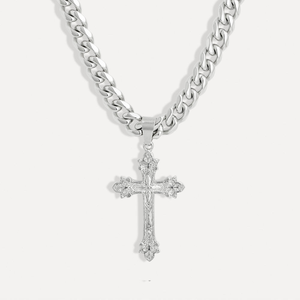 Silver cross pendant on a chain against a white background