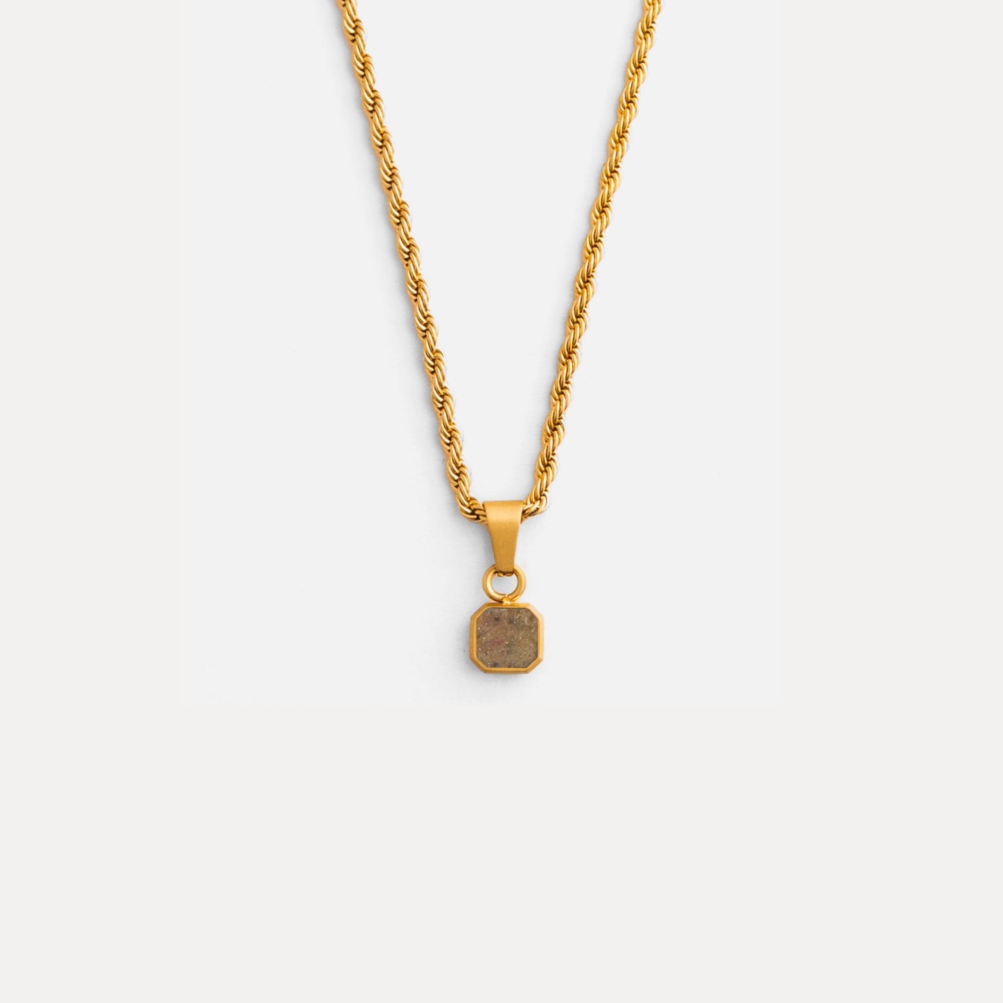 Gold necklace with a pendant on a white background