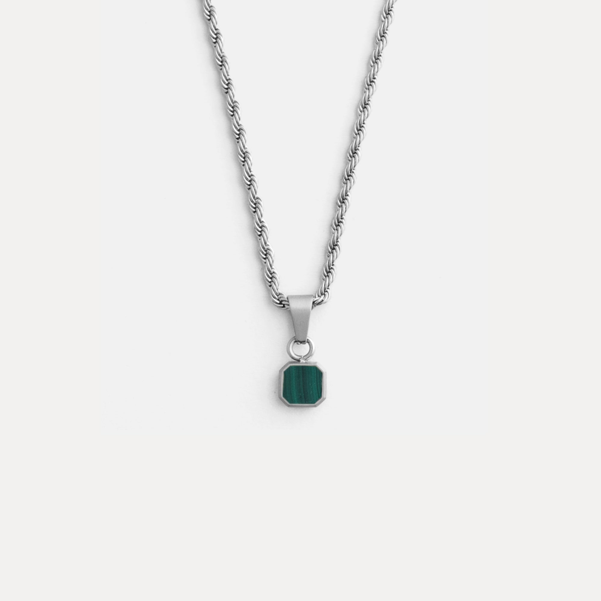 Necklace with a green pendant on a white background