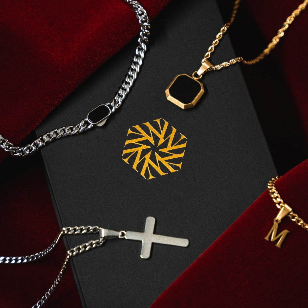 Jewelry including necklaces and a pendant on a black and red background