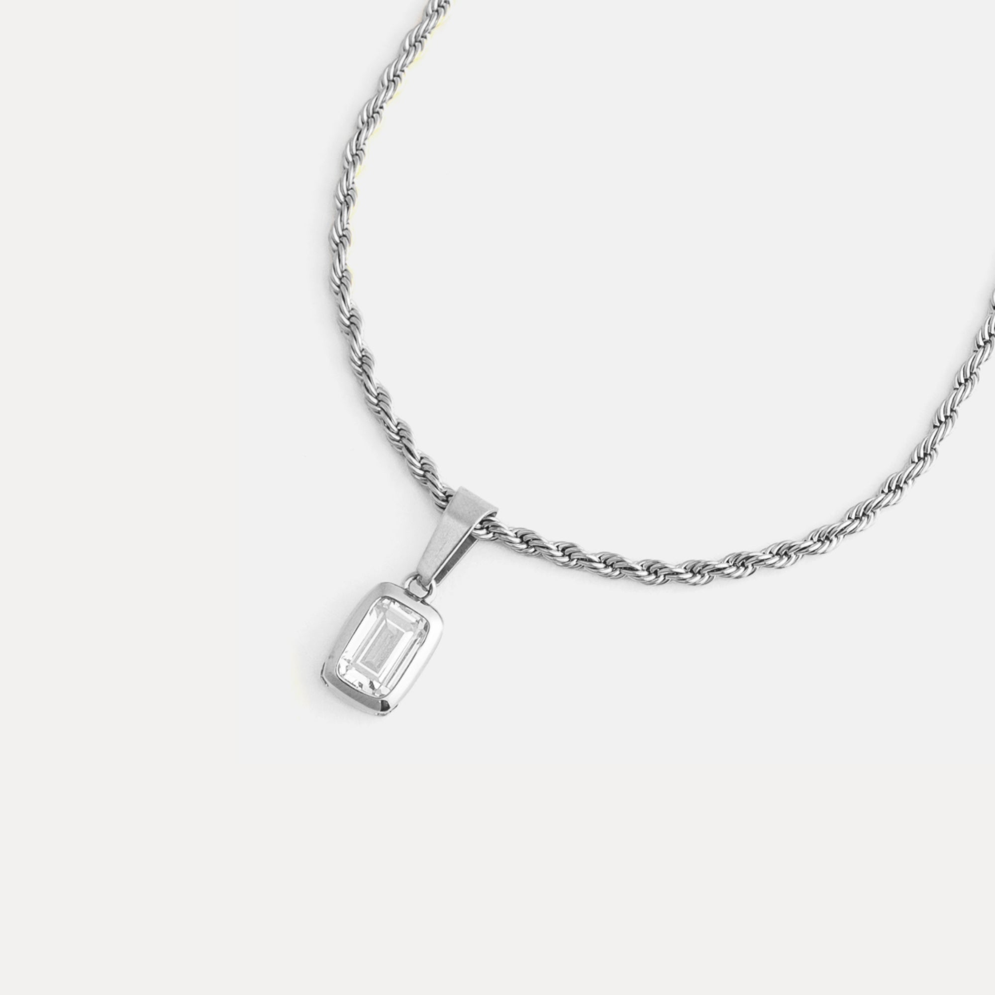 Silver necklace with a pendant on a white background