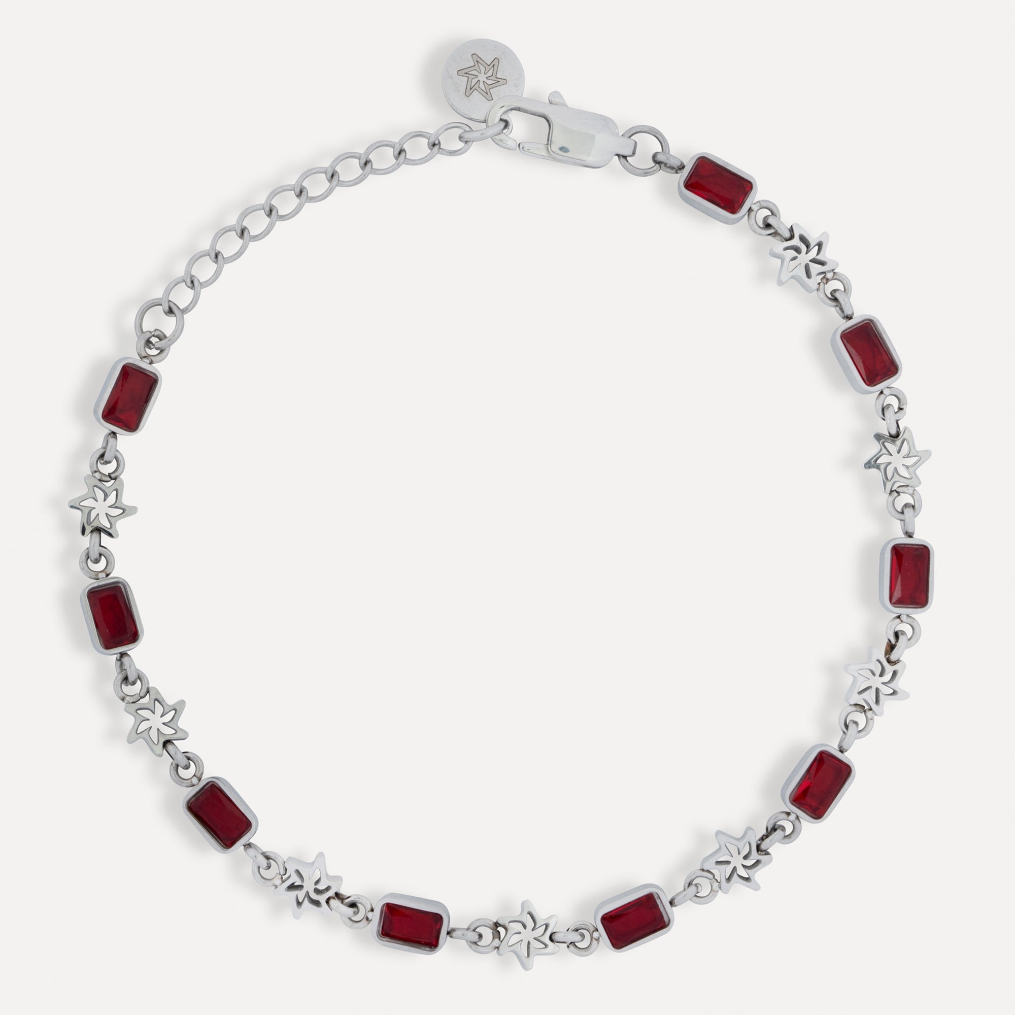 Silver bracelet with red square stones on a white background