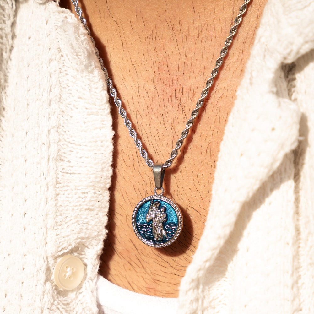 Necklace with a pendant worn by a person wearing a white sweater.