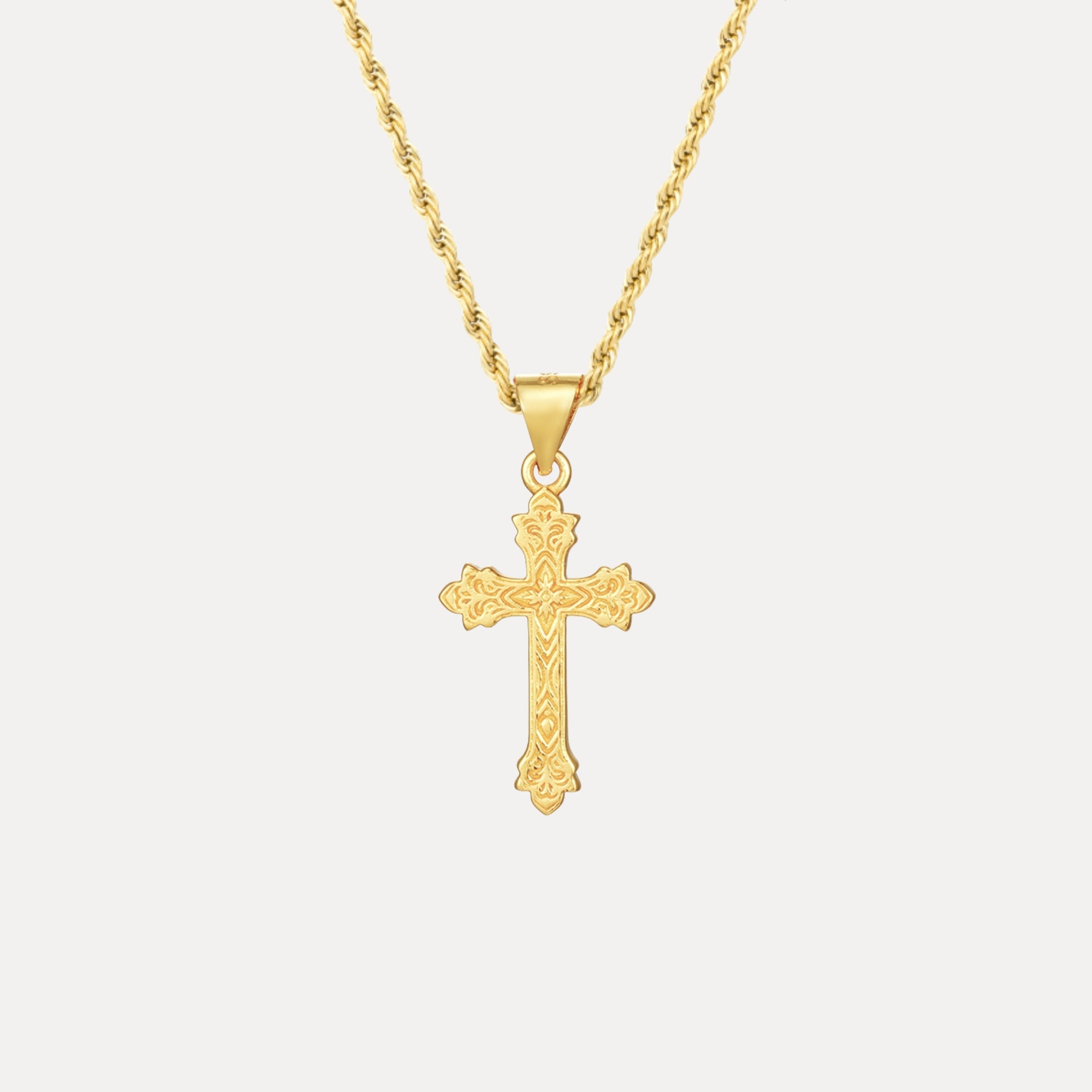 Gold cross pendant necklace on a white background