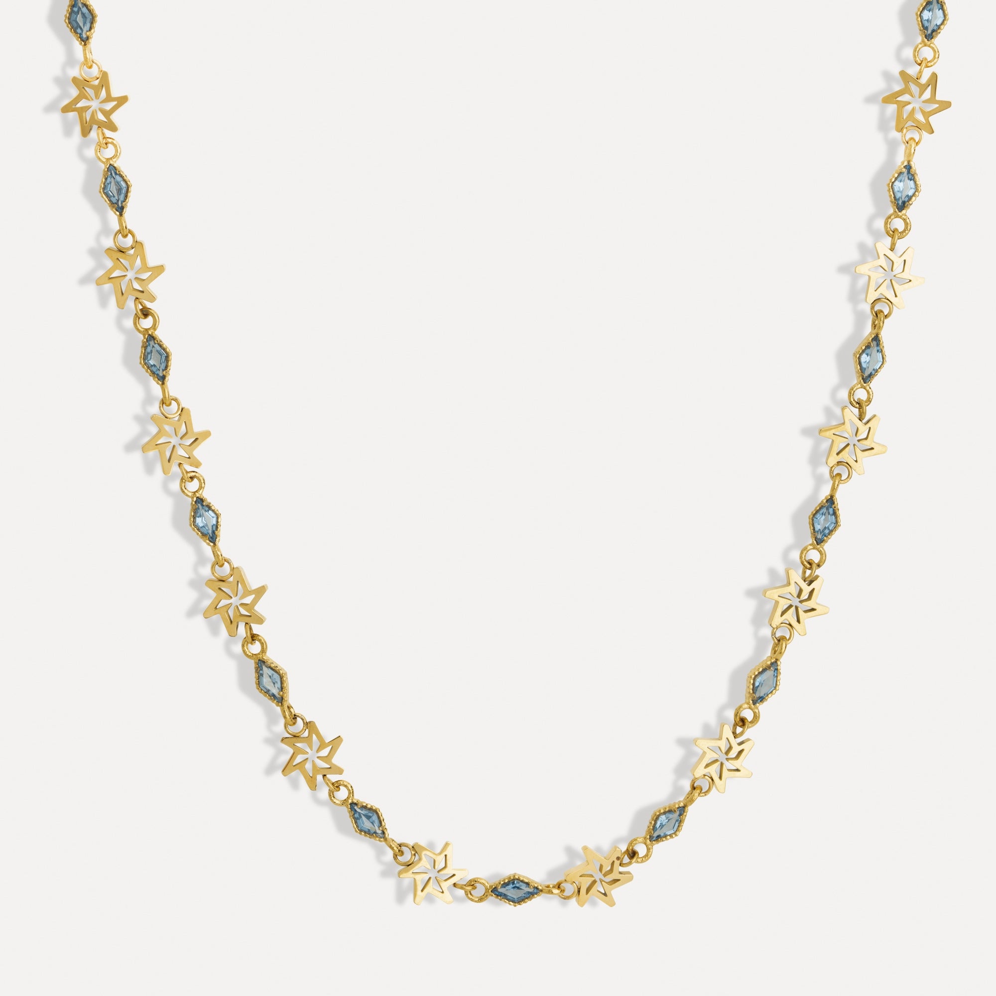 Gold necklace with star-shaped links on a white background