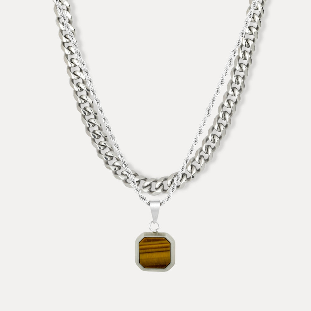 Silver chain necklace with a tiger's eye pendant on a white background