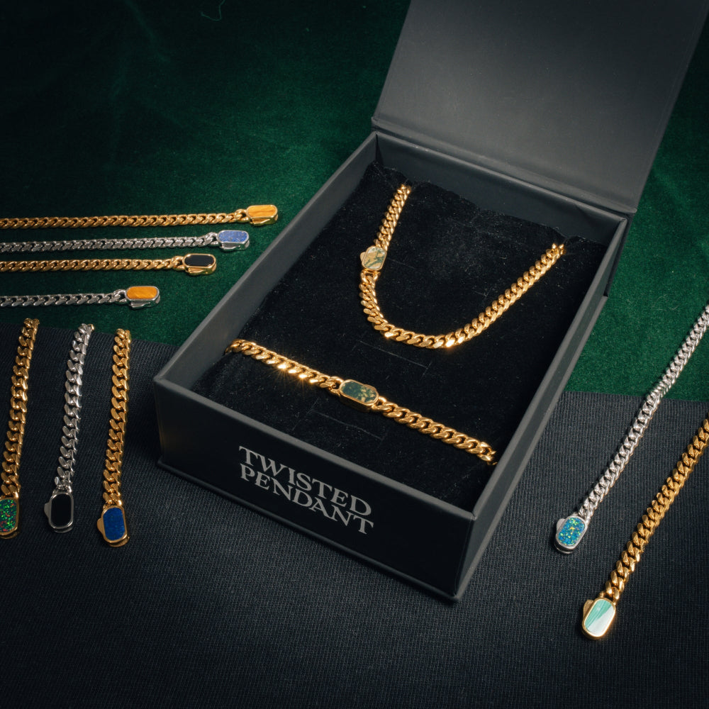 Gold chain jewelry set with 'Twisted Pendant' branding on a dark surface.