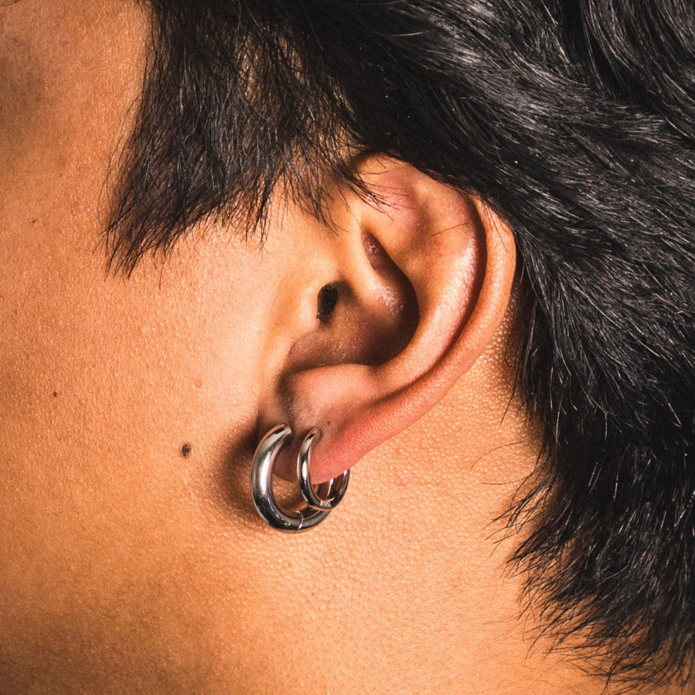 Close-up of an ear with a silver hoop earring