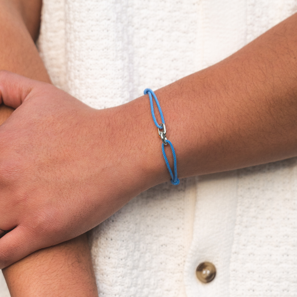 An adjustable bracelet made of deep blue nylon and 925 sterling silver, displayed on a person's wrist.