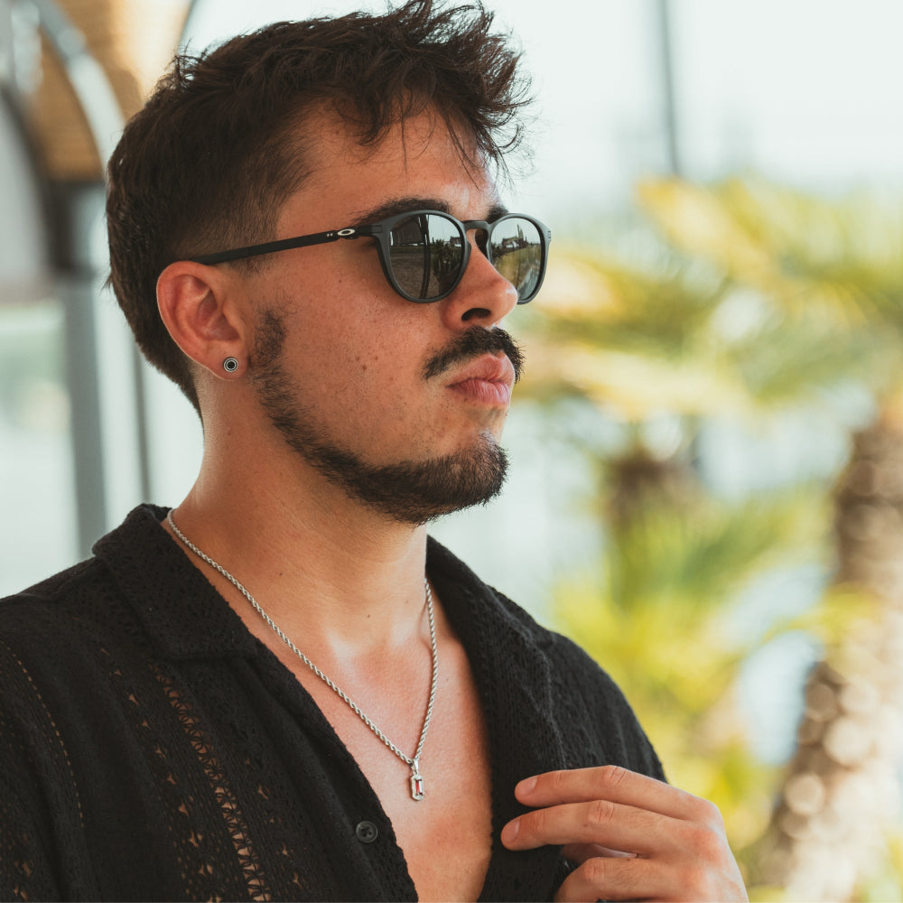 Man wearing sunglasses with a blurred natural background
