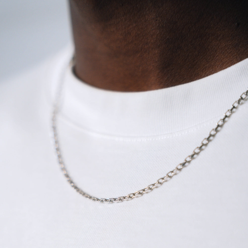 Silver chain necklace on a mannequin with a white background