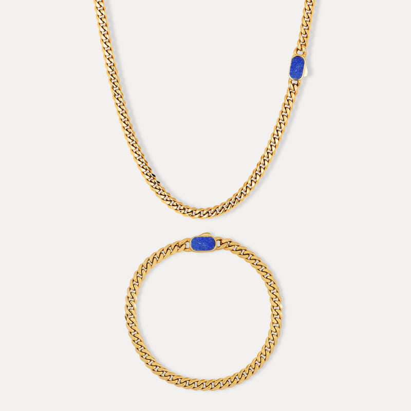 Gold chain necklace and bracelet with blue accents on a white background