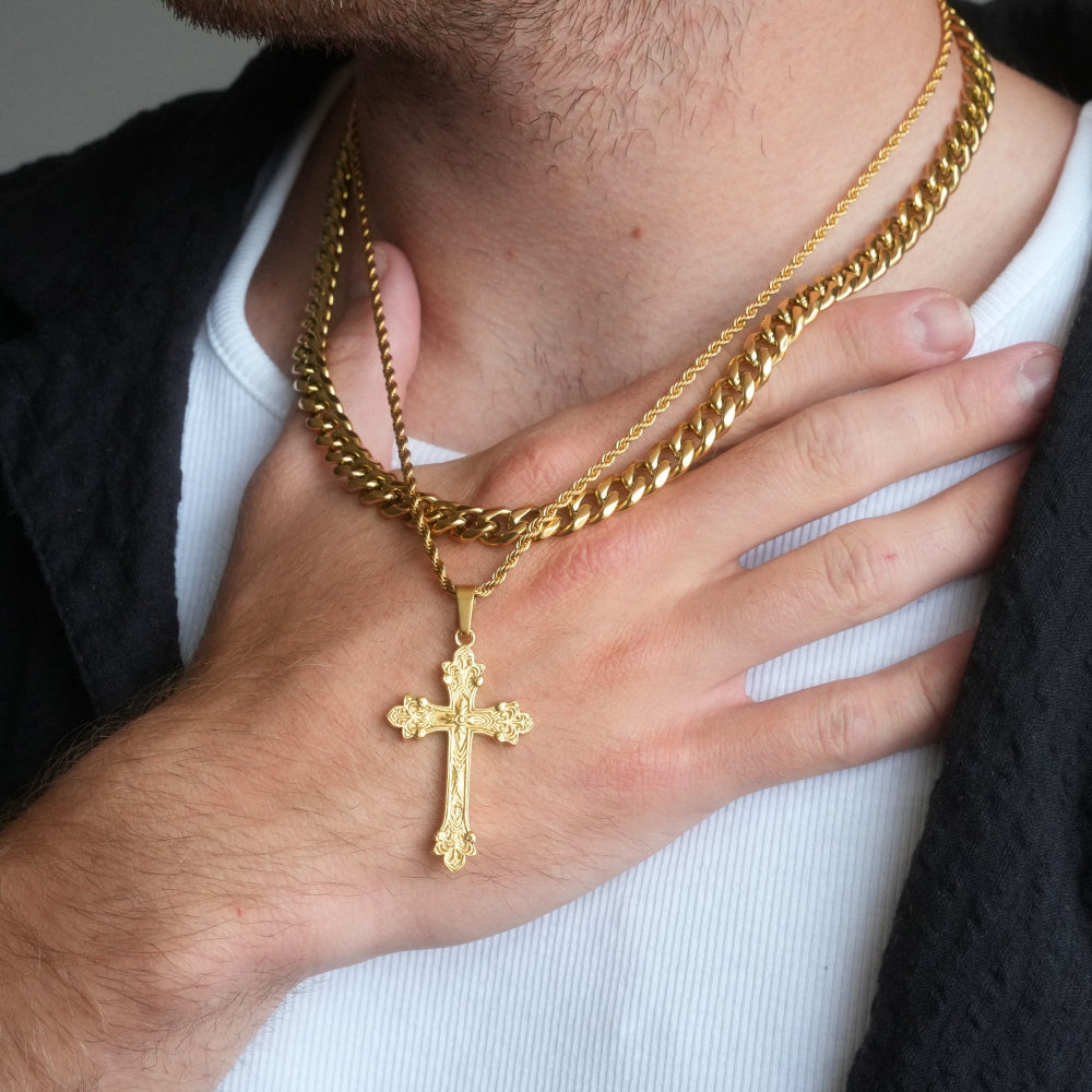 Gold chain with a cross pendant worn by a person
