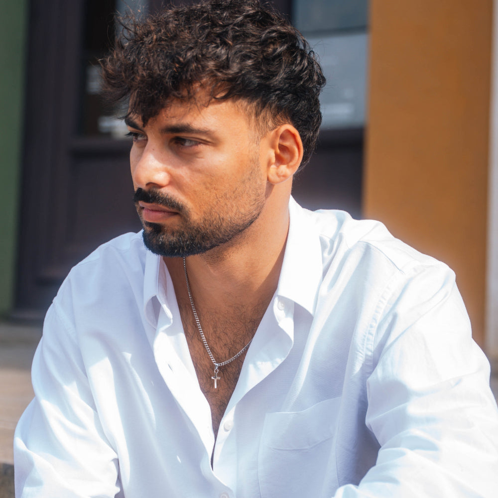 Man wearing a white shirt with a blurred background