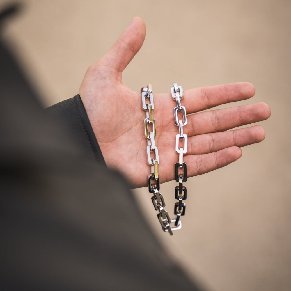 Hand holding a chain with a blurred background