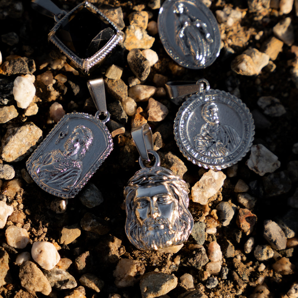 Silver pendants on a textured surface