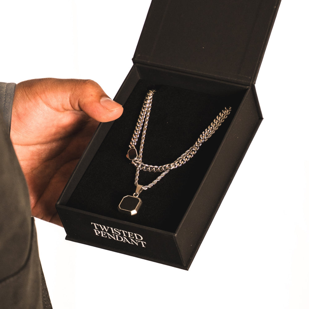 Gold chain necklace with a pendant in a black box labeled 'Twisted Pendant'.