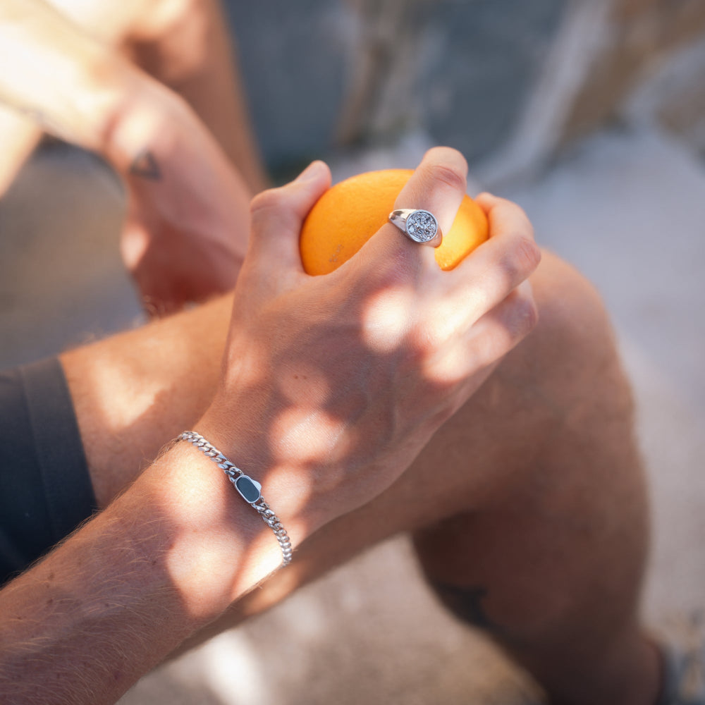 Close-up of hands holding an orange ball with a blurred background