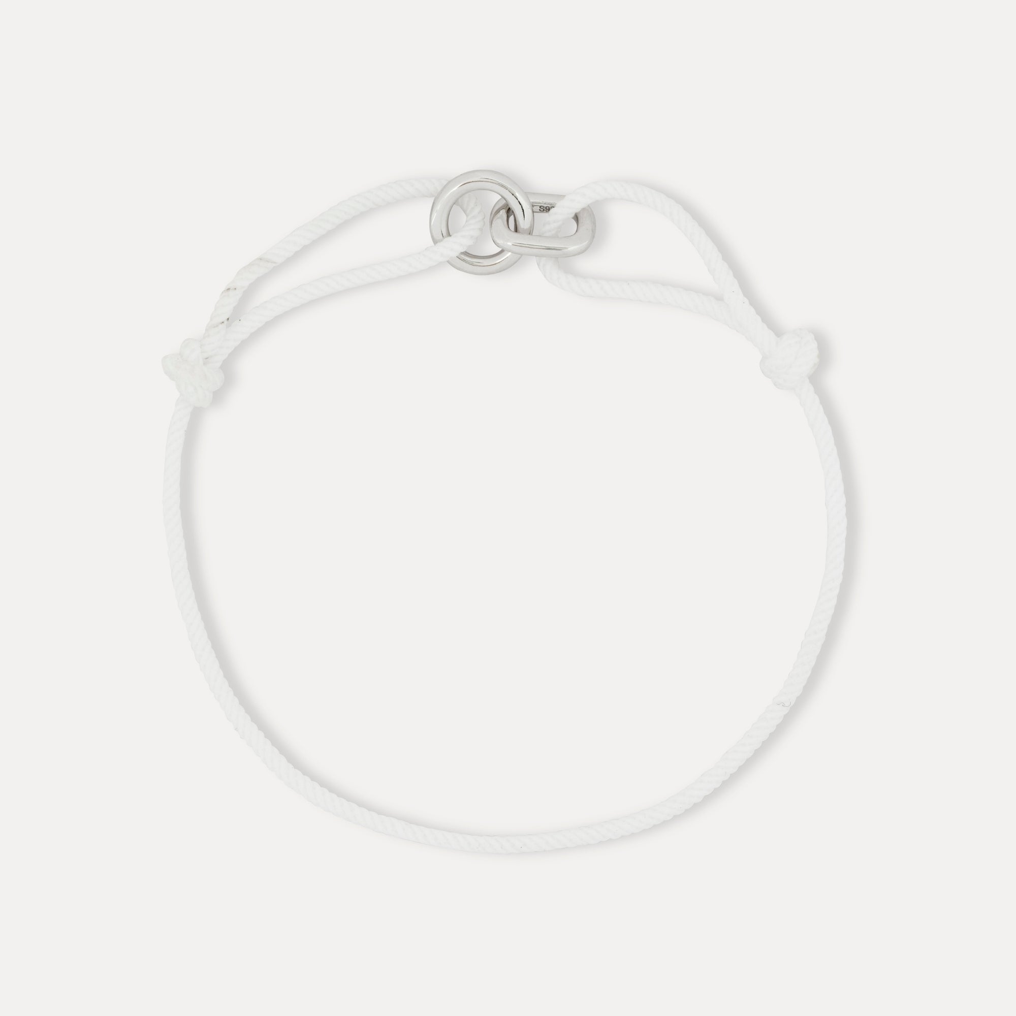 Silver bracelet on a light gray background
